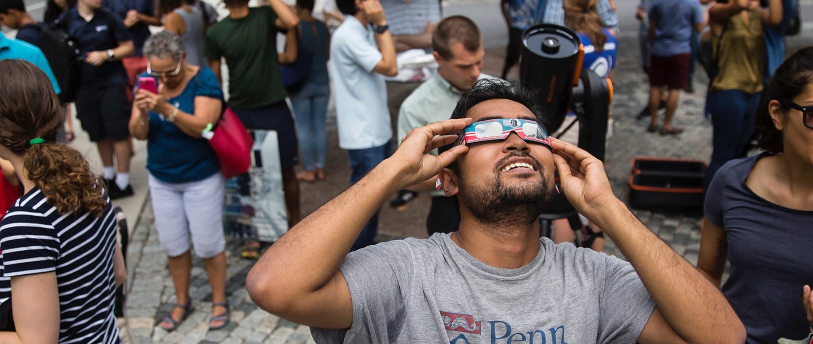 Student looking up at solar eclipse