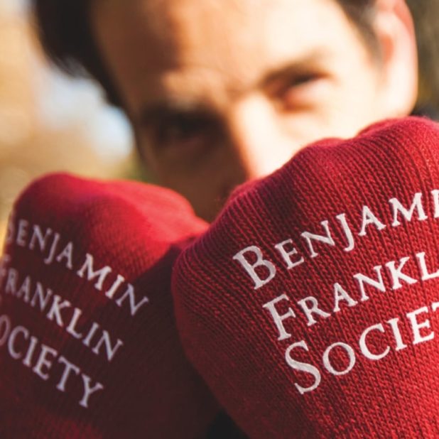 Man wearing Benjamin Franklin Society gloves