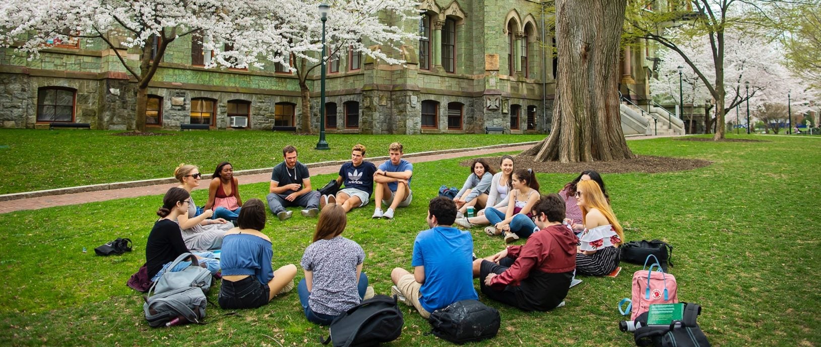 Students sitting in a circle on campus