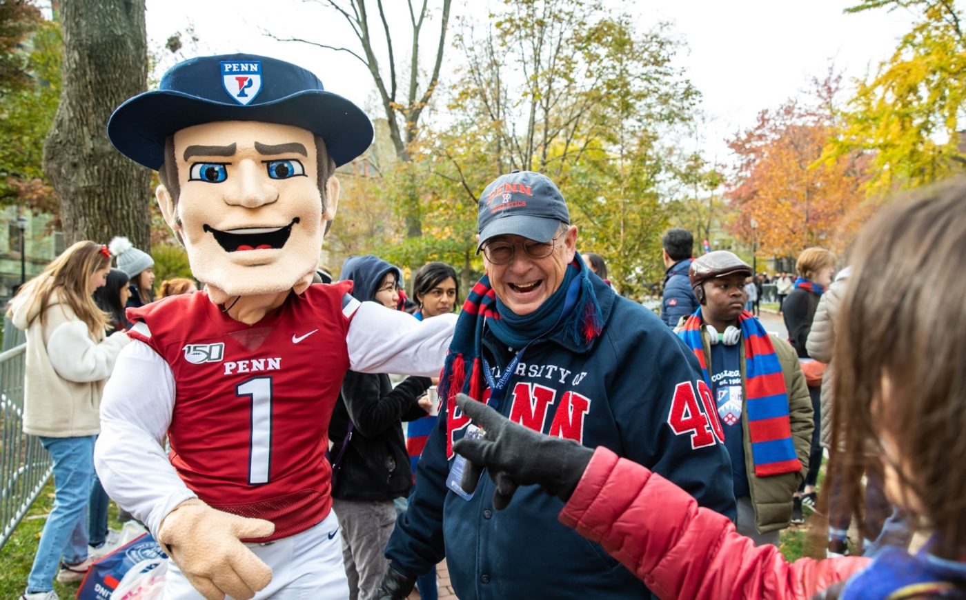 Man with Mascot at Quaker Fest during Homecoming Weekend