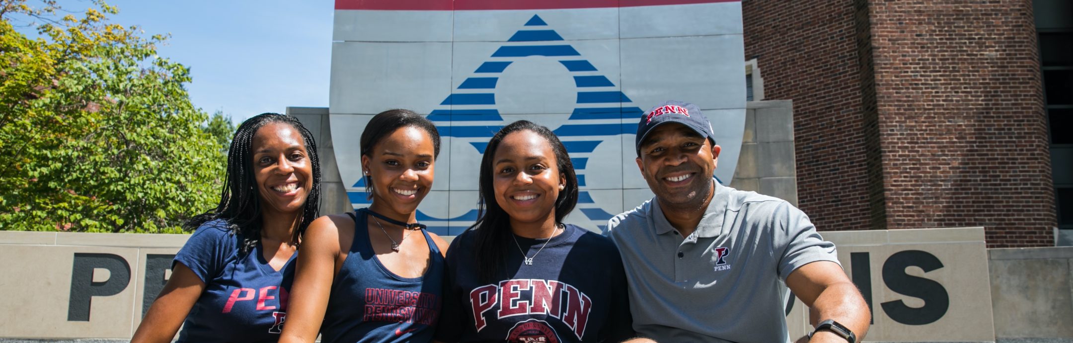 Happy Penn family sitting on steps